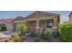 Beautiful front exterior with a two-car garage, landscaped yard, and covered porch at 18187 W Via Montoya Dr, Surprise, AZ 85387