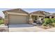 Charming single-story home with well-manicured landscaping and a two-car garage at 18187 W Via Montoya Dr, Surprise, AZ 85387