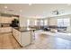 Open-concept kitchen featuring an island, modern appliances, and views of dining and living areas at 18187 W Via Montoya Dr, Surprise, AZ 85387