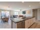 Bright kitchen with stainless steel appliances and island overlooking dining and living area at 18187 W Via Montoya Dr, Surprise, AZ 85387