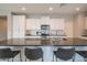 Inviting kitchen with a large island, modern appliances, white cabinets and bar stool seating at 18187 W Via Montoya Dr, Surprise, AZ 85387