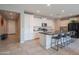 Spacious kitchen featuring white cabinets, a large island with seating, and modern stainless steel appliances at 18187 W Via Montoya Dr, Surprise, AZ 85387