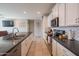 Spacious kitchen boasting white cabinetry, stainless steel appliances and a large island with bar seating at 18187 W Via Montoya Dr, Surprise, AZ 85387