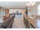 Bright, open-concept living area featuring a modern kitchen, dining area, and cozy seating arrangements at 18187 W Via Montoya Dr, Surprise, AZ 85387