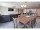 Inviting living space with an open floor plan, connecting the kitchen, dining, and living areas at 18187 W Via Montoya Dr, Surprise, AZ 85387