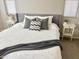 Close up of a beautifully appointed bed with plush pillows, side tables and soft decor accents at 18187 W Via Montoya Dr, Surprise, AZ 85387
