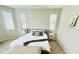Cozy main bedroom with natural light, neutral colors and ensuite bathroom at 18187 W Via Montoya Dr, Surprise, AZ 85387