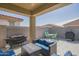 Outdoor patio with cozy seating, dining area, and grill, perfect for entertaining at 18187 W Via Montoya Dr, Surprise, AZ 85387