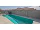 A private in-ground swimming pool is surrounded by a tall block fence for privacy at 18187 W Via Montoya Dr, Surprise, AZ 85387