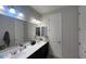 Bathroom featuring a double sink vanity with ample counter space and large mirrors at 18542 W Luke Ave, Litchfield Park, AZ 85340