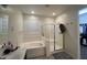 Bright bathroom with a soaking tub and a separate glass-enclosed shower with modern fixtures at 18542 W Luke Ave, Litchfield Park, AZ 85340