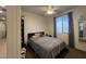 Cozy bedroom with natural light, a comfortable bed with gray linens, and a ceiling fan at 18542 W Luke Ave, Litchfield Park, AZ 85340