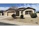 Attractive home featuring a three car garage, low-maintenance desert landscaping and shuttered windows at 18542 W Luke Ave, Litchfield Park, AZ 85340
