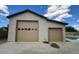 Detached garage with two garage doors, one with windows, next to a pool at 18542 W Luke Ave, Litchfield Park, AZ 85340