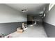Spacious garage with two-tone paint, concrete floors, and drop ceiling at 18542 W Luke Ave, Litchfield Park, AZ 85340