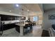 The kitchen has a large granite island with seating, dark cabinetry, and a view of the dining area at 18542 W Luke Ave, Litchfield Park, AZ 85340