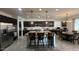 Wide angle view of the open kitchen with granite counters, bar seating, and stainless steel appliances at 18542 W Luke Ave, Litchfield Park, AZ 85340