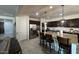 This spacious kitchen features a large granite island, dark cabinets, and stainless steel appliances at 18542 W Luke Ave, Litchfield Park, AZ 85340