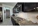 The kitchen features dark cabinets, granite countertops, stainless steel appliances, and a gas cooktop at 18542 W Luke Ave, Litchfield Park, AZ 85340
