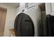 Practical laundry room with white cabinets, a butcher block countertop, and modern appliances at 18542 W Luke Ave, Litchfield Park, AZ 85340