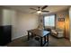 Comfortable living room with carpet, neutral walls, a ceiling fan and a large cabinet at 18542 W Luke Ave, Litchfield Park, AZ 85340