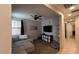Spacious living room with gray sectional sofa, flat screen TV, ceiling fan, and neutral decor at 18542 W Luke Ave, Litchfield Park, AZ 85340