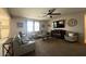 Comfortable living room showcasing plush seating, a cozy fireplace, and a mounted television at 18542 W Luke Ave, Litchfield Park, AZ 85340