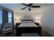 Serene main bedroom featuring a ceiling fan, carpet flooring, and natural light from the large window at 18542 W Luke Ave, Litchfield Park, AZ 85340