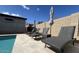 Lounge chairs with umbrellas alongside a pool offer relaxation and shade at 18542 W Luke Ave, Litchfield Park, AZ 85340