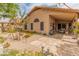 Charming backyard with covered patio, desert landscaping, and exterior view of home at 18886 N 77Th Ave, Glendale, AZ 85308