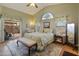 Bright bedroom featuring a cozy sitting area, sliding doors and patterned bedding at 18886 N 77Th Ave, Glendale, AZ 85308