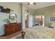 Bedroom featuring wooden floors, patterned bedding, and dark wood dresser at 18886 N 77Th Ave, Glendale, AZ 85308