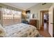 Bedroom featuring patterned bedding, a TV, and a dark wood dresser at 18886 N 77Th Ave, Glendale, AZ 85308