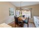 Cozy dining area with wood table, chairs, a window, and a decorative chandelier at 18886 N 77Th Ave, Glendale, AZ 85308