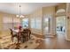 Well-lit dining area with a chandelier and lots of windows to enjoy the sunshine in the comfort of your home at 18886 N 77Th Ave, Glendale, AZ 85308