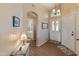 Inviting entryway with tiled floors, a decorative light fixture, and access to the bathroom at 18886 N 77Th Ave, Glendale, AZ 85308