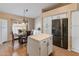 Bright kitchen with an island, white cabinets, a stainless steel refrigerator, and a dining area at 18886 N 77Th Ave, Glendale, AZ 85308