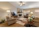 Cozy living room featuring a fireplace, soft lighting, and plush seating, perfect for relaxing or entertaining guests at 18886 N 77Th Ave, Glendale, AZ 85308