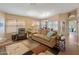 Comfortable living room with a sofa, chair, and large windows that flood the space with natural light at 18886 N 77Th Ave, Glendale, AZ 85308