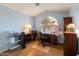 Bright office space with desk, shelving, and a large window offering natural light at 18886 N 77Th Ave, Glendale, AZ 85308