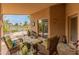 Inviting covered patio with wicker furniture and peaceful views of the water at 18886 N 77Th Ave, Glendale, AZ 85308