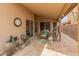 Relaxing covered patio with tiled flooring and well-kept landscaping at 18886 N 77Th Ave, Glendale, AZ 85308