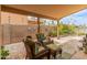 Covered outdoor patio with comfortable seating overlooking lush landscaping and water feature at 18886 N 77Th Ave, Glendale, AZ 85308