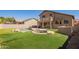 Backyard with a built in pool and spa, covered patio, and artificial grass at 22236 N 48Th St, Phoenix, AZ 85054