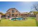 Large backyard with a custom pool, patio, and lush artificial turf area at 22236 N 48Th St, Phoenix, AZ 85054