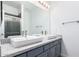 Modern bathroom featuring double sinks with granite countertops, modern vanity lighting, and updated fixtures at 22236 N 48Th St, Phoenix, AZ 85054