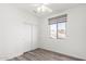 Well-lit bedroom featuring a window with a view, a ceiling fan, and a closet with sliding doors at 22236 N 48Th St, Phoenix, AZ 85054