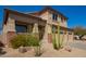 Inviting home featuring brick accents, a covered porch, and low-maintenance desert landscaping at 22236 N 48Th St, Phoenix, AZ 85054