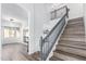 Elegant staircase with wood treads and gray banister, leading to an upper level at 22236 N 48Th St, Phoenix, AZ 85054