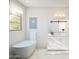 Elegant bathroom featuring a freestanding tub, modern vanity, and bright natural light at 2370 W Los Arboles Pl, Chandler, AZ 85224